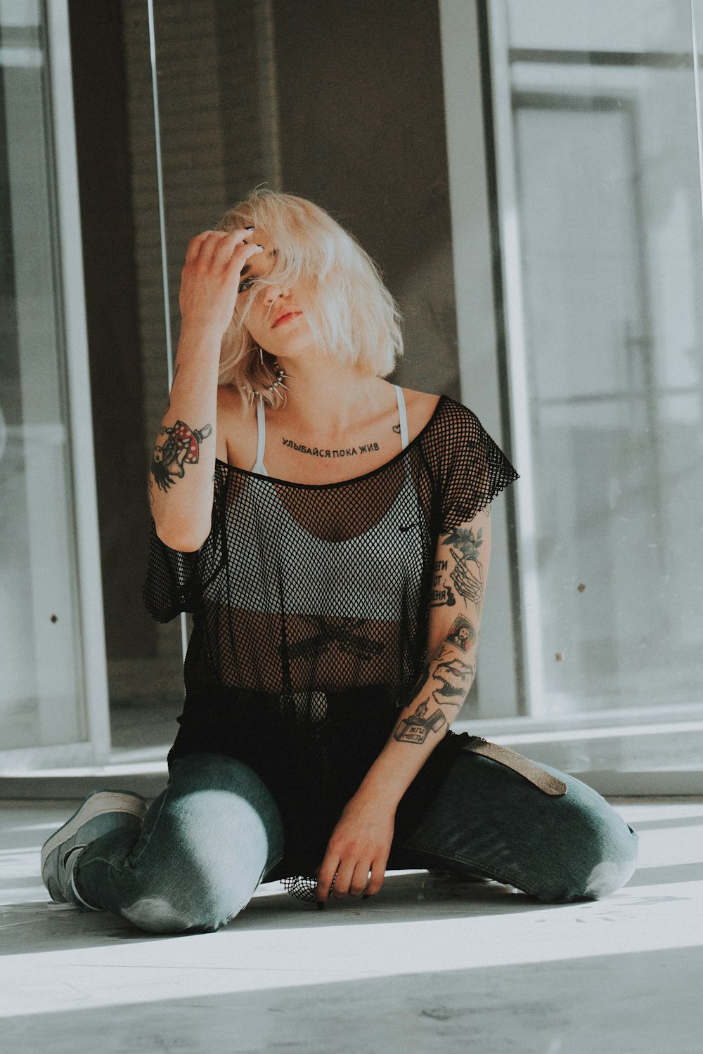 woman sitting on floor holding her hair