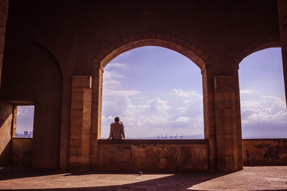 person sitting on wall