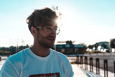 Lifestyle shot of a young person wearing an Afro-t-shirt in a sunny urban setting.
