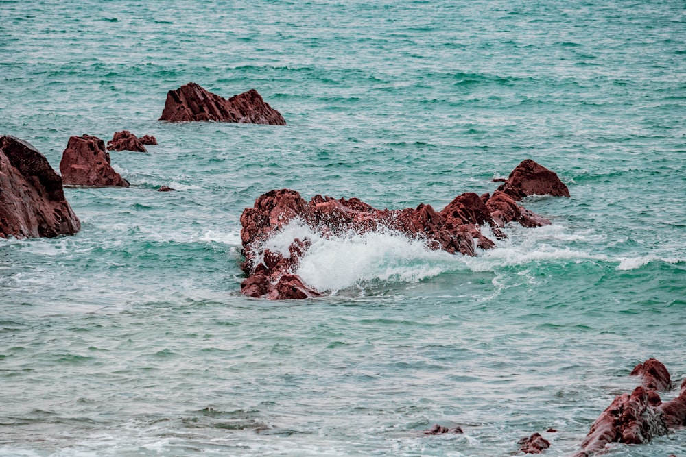 brown rocks on body of water photo