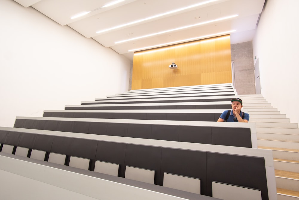 man sitting inside auditorium