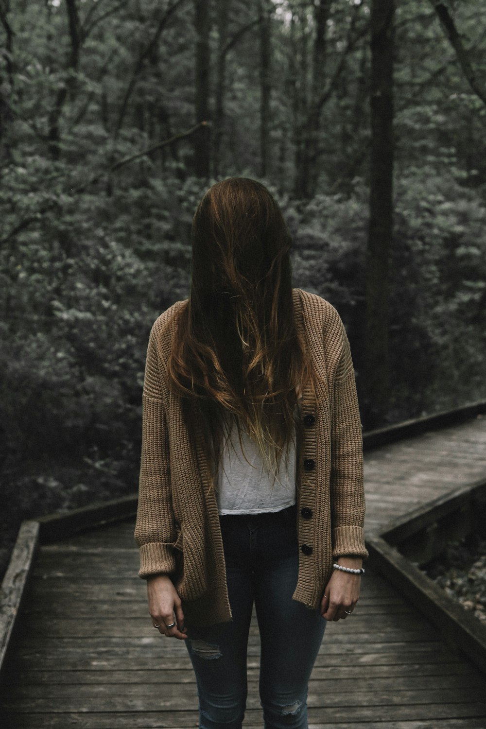 selective focus photo of woman standing on dock