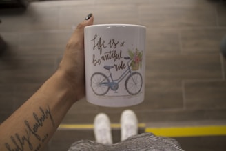 person holding white mug