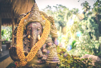 Close-up of a hand-painted eco-friendly Ganesh idol with intricate details and earthy tones.