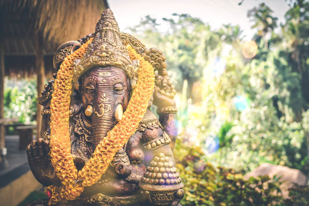 Close-up of a hand-painted eco-friendly Ganesh idol with intricate details and earthy tones.
