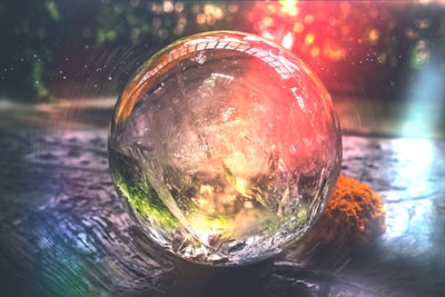 An ethereal image of a crystal ball glowing softly in a dimly lit room.