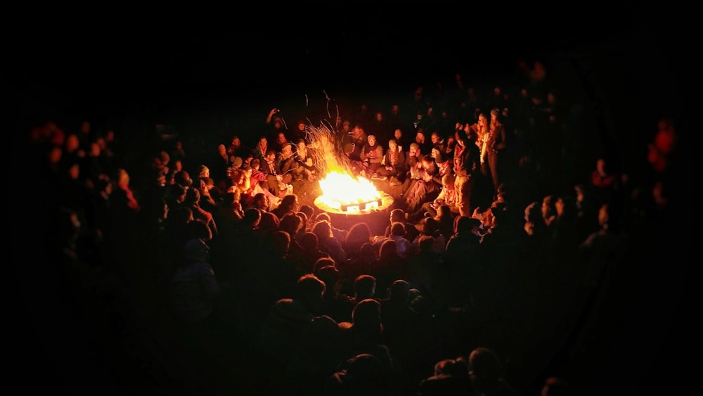 people gathering near bonefire