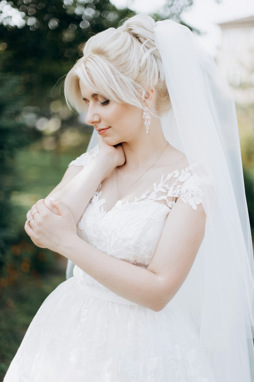 woman in white wedding dress standing at daytime