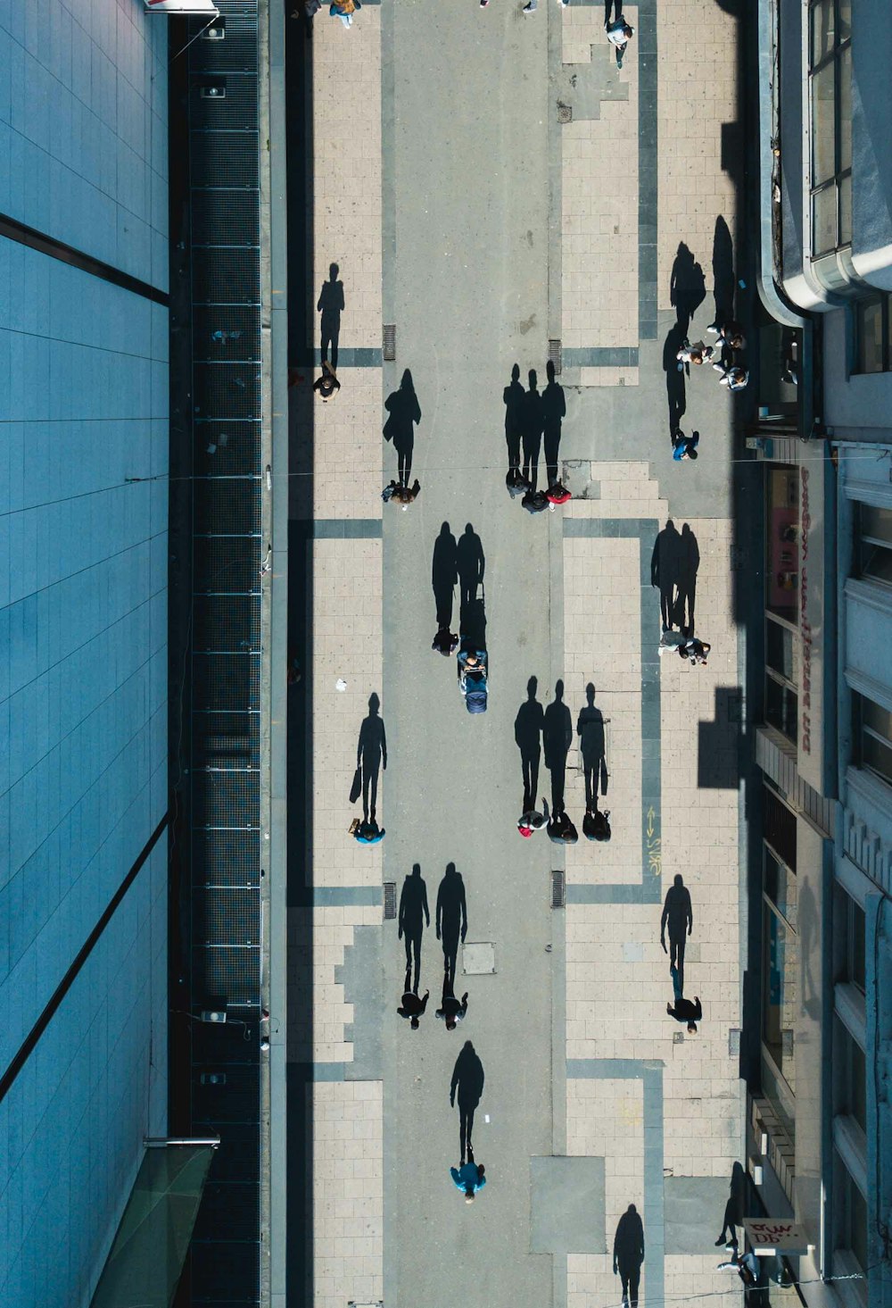 people walking on street between buildings