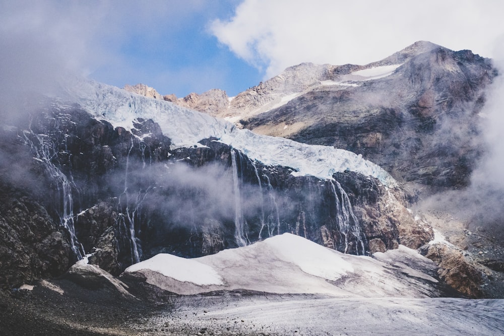 snow-covered mountain with waterfalls