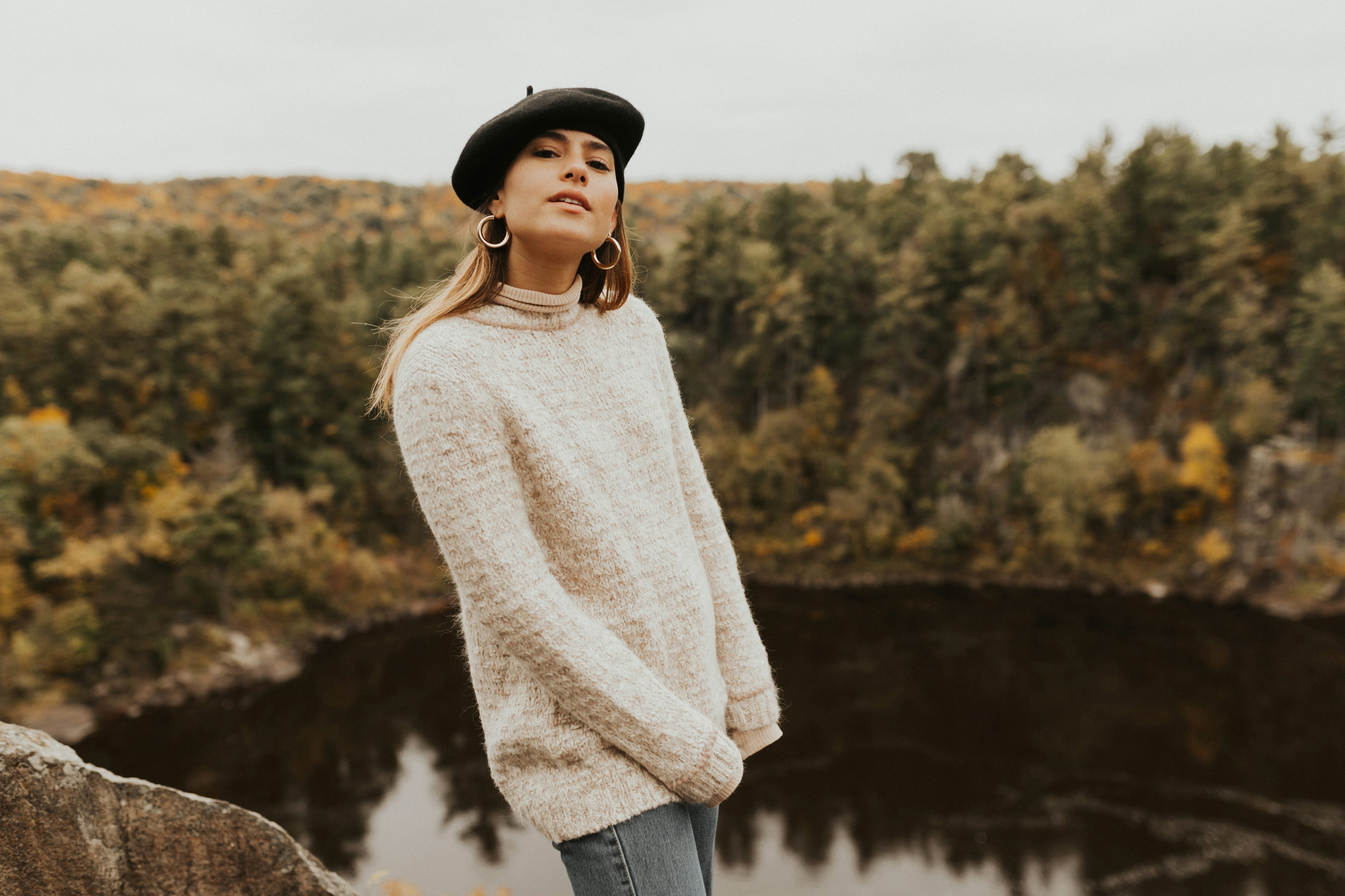 woman wearing beige sweater on top of hill