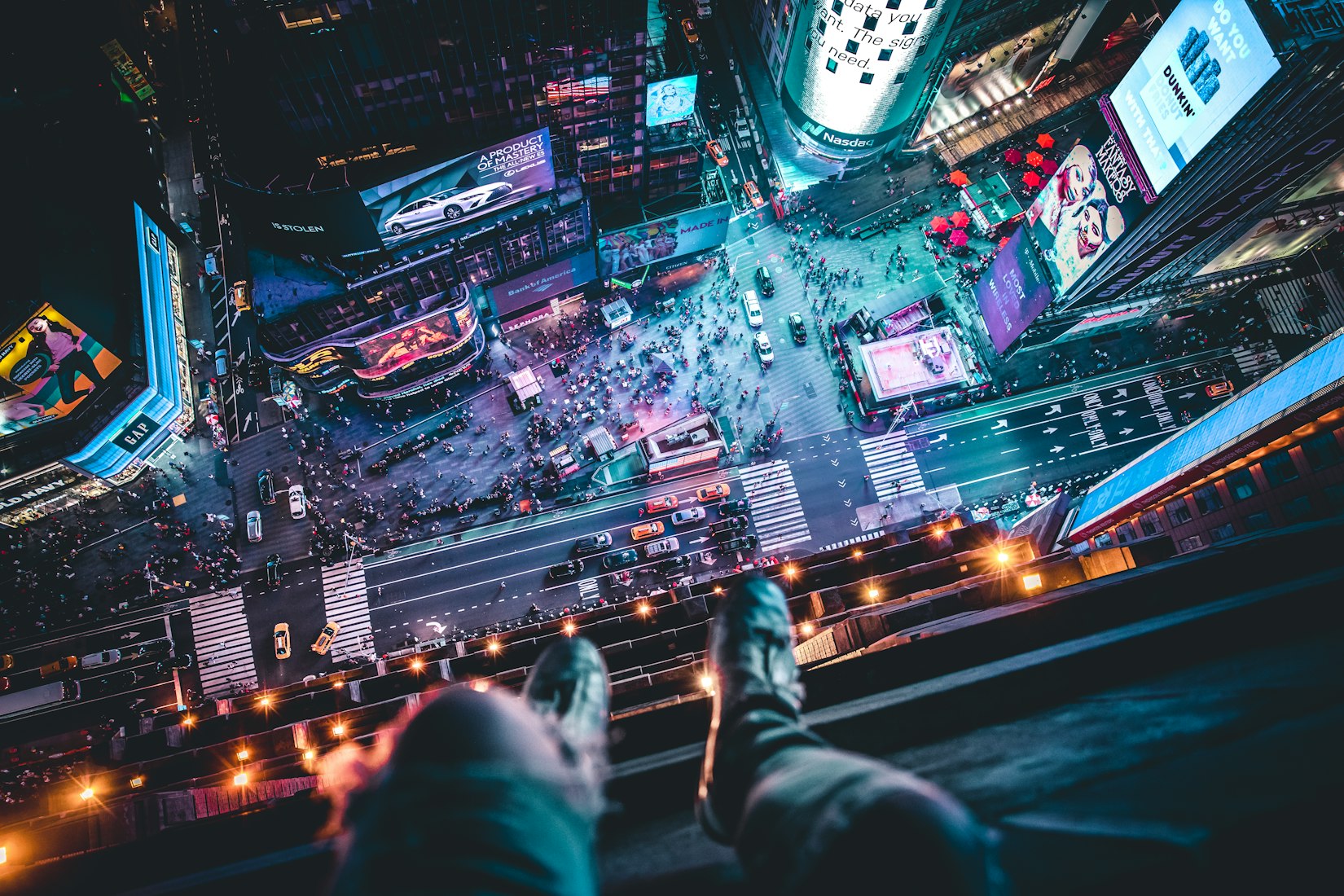 Somebody hanging above Times Square in New York City (Andre Benz via Unsplash)