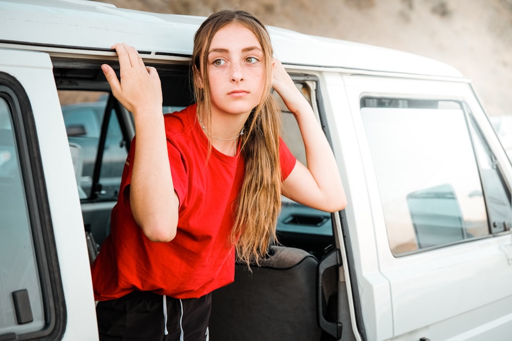 woman standing on white vehicle