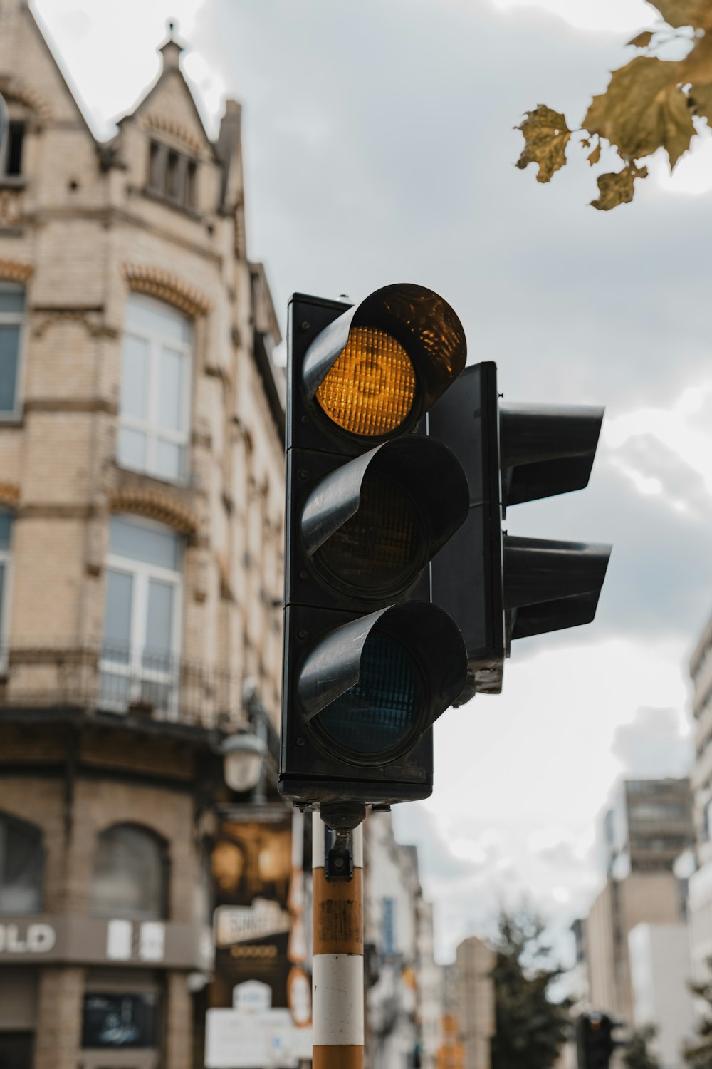 closeup photography of traffic light on orange light during daytime