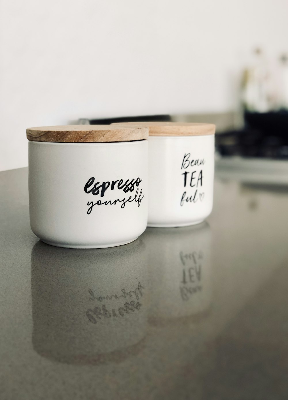 two white ceramic container on gray marble surface