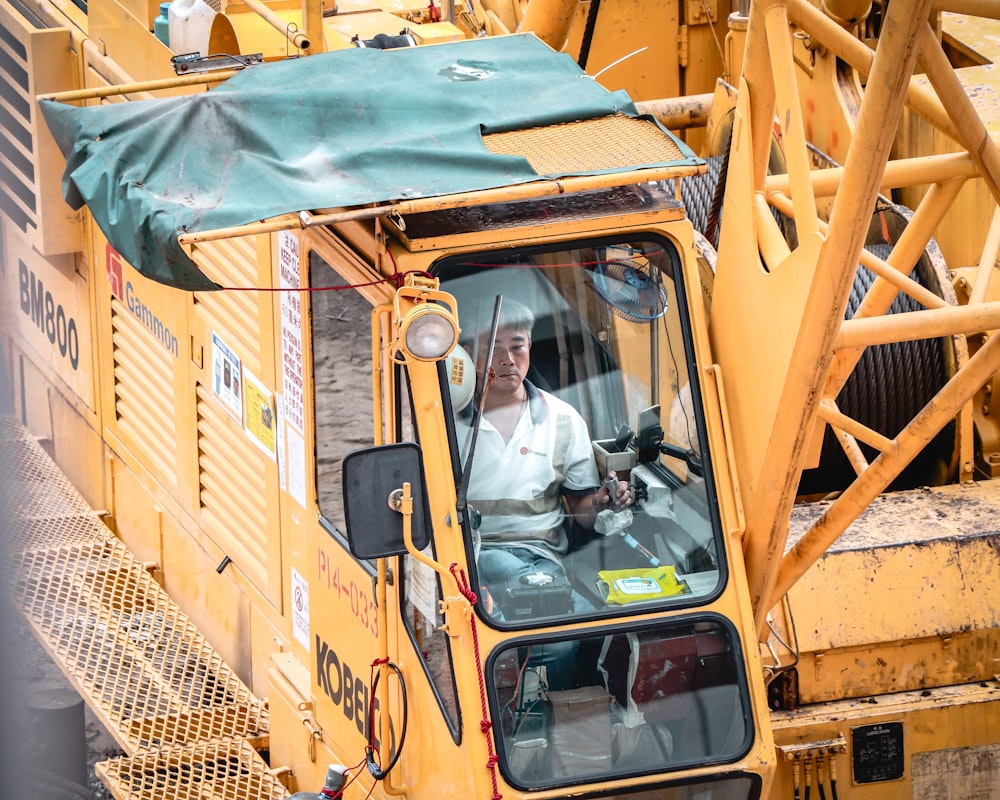 man inside heavy equipment truck