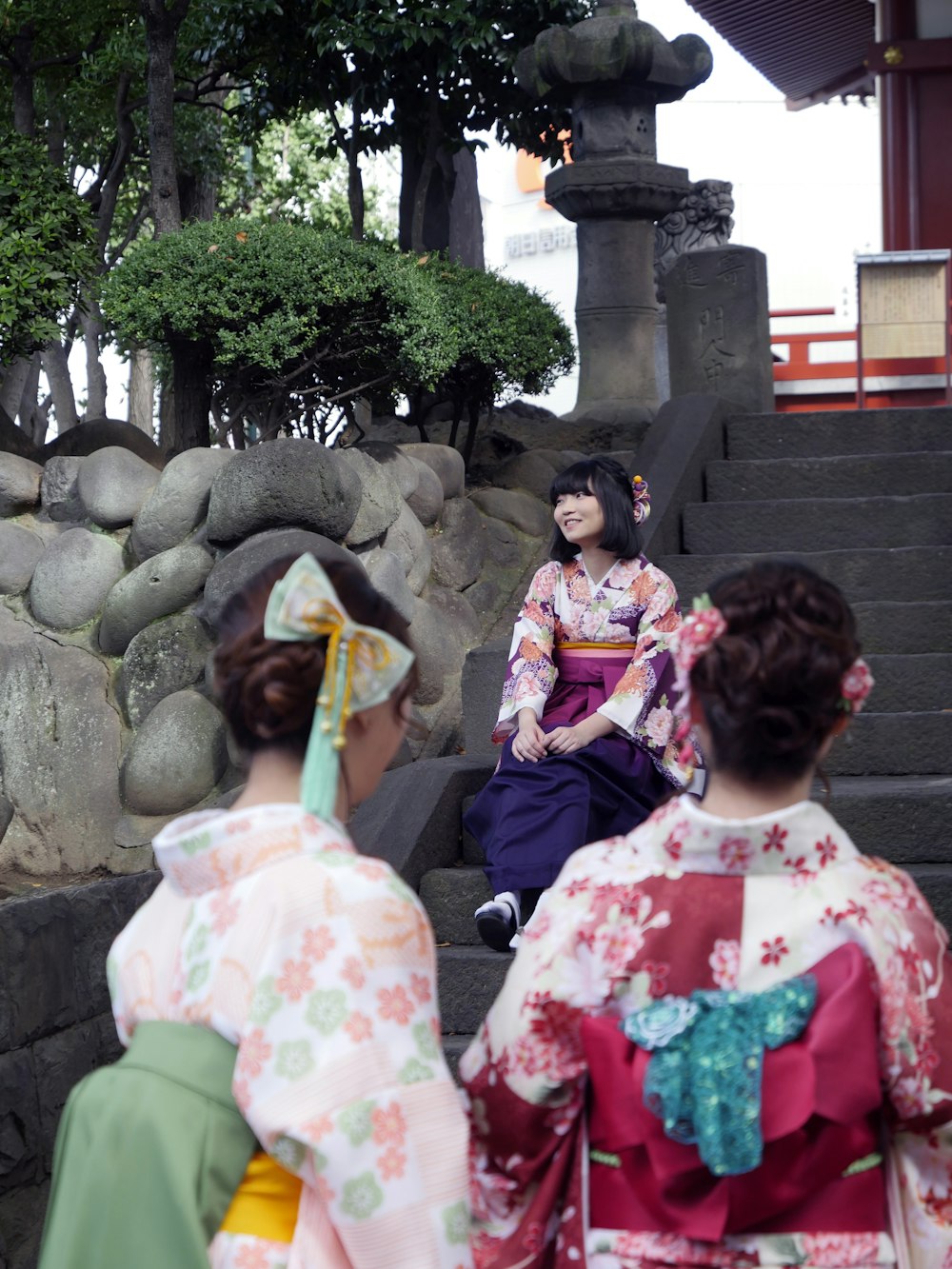 three women wearing kimono dresses