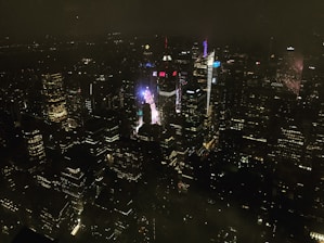 A creative digital billboard lighting up a city skyline at night.