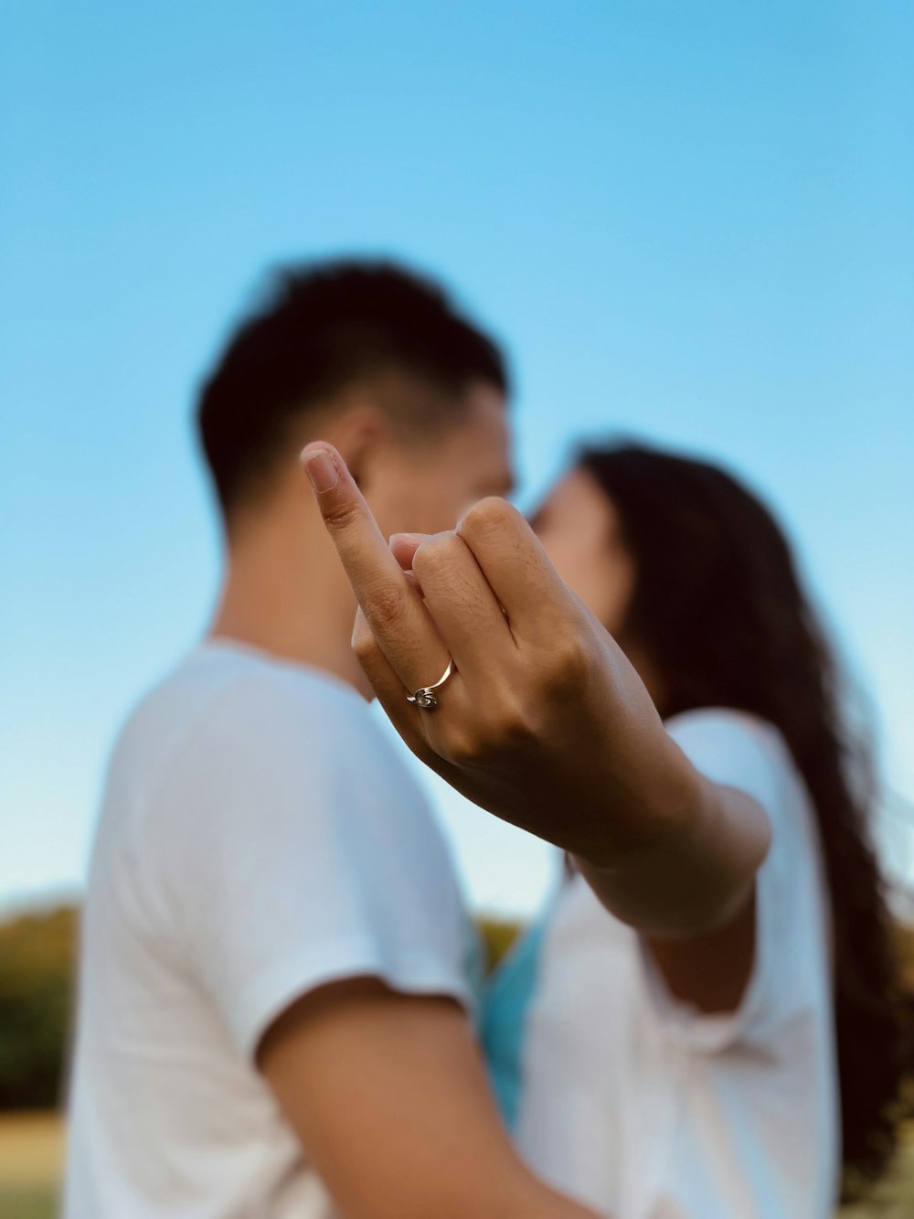 woman standing near man making finger sign