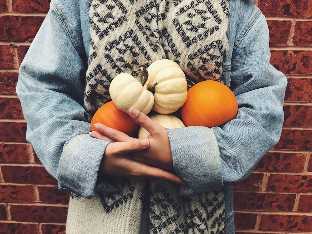 woman carrying pumpkins