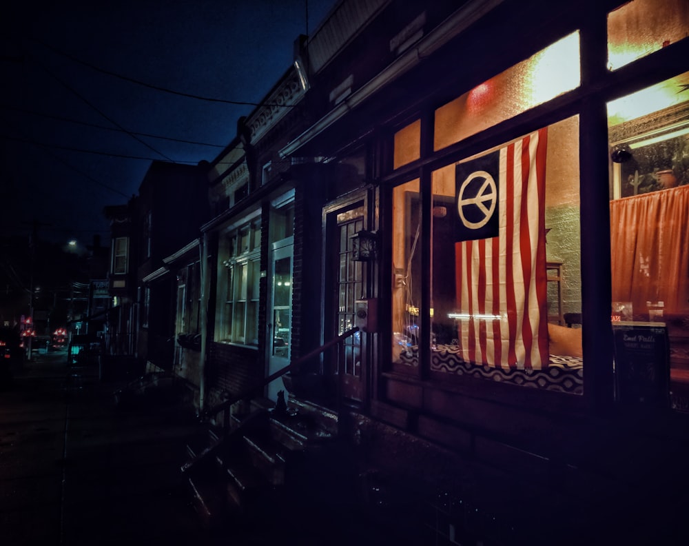 store front with a flag on the window