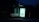 A dimly lit bus stop bench is illuminated by an advertisement panel displaying an internet service promotion. The surrounding area is dark, with the advertisement text prominently visible.