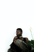 A woman wearing stylish sunglasses and a minimalistic necklace.