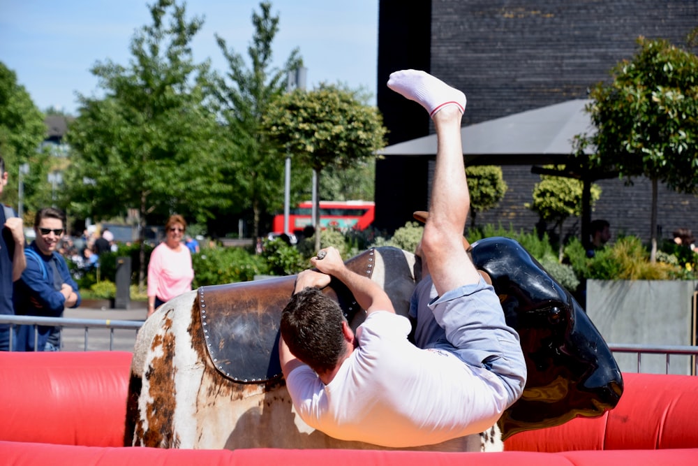 man riding bull during daytime