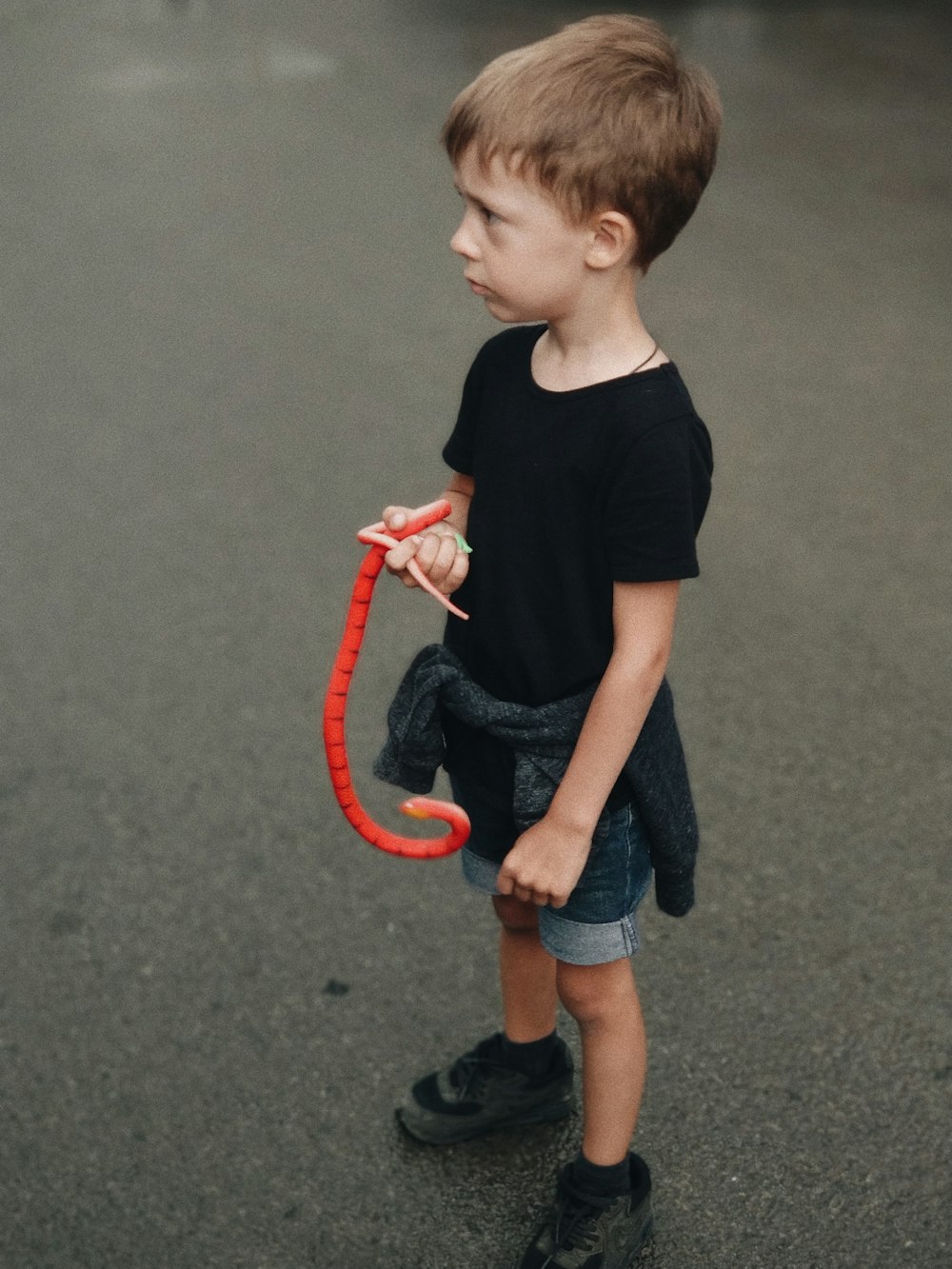 boy holding red snake toy