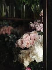 Luxurious floral arrangement with soft pink roses in an elegant living room setting.