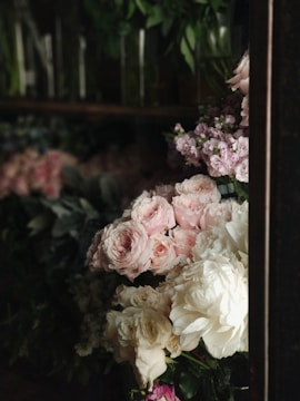 Luxurious floral arrangement with soft pink roses in an elegant living room setting.