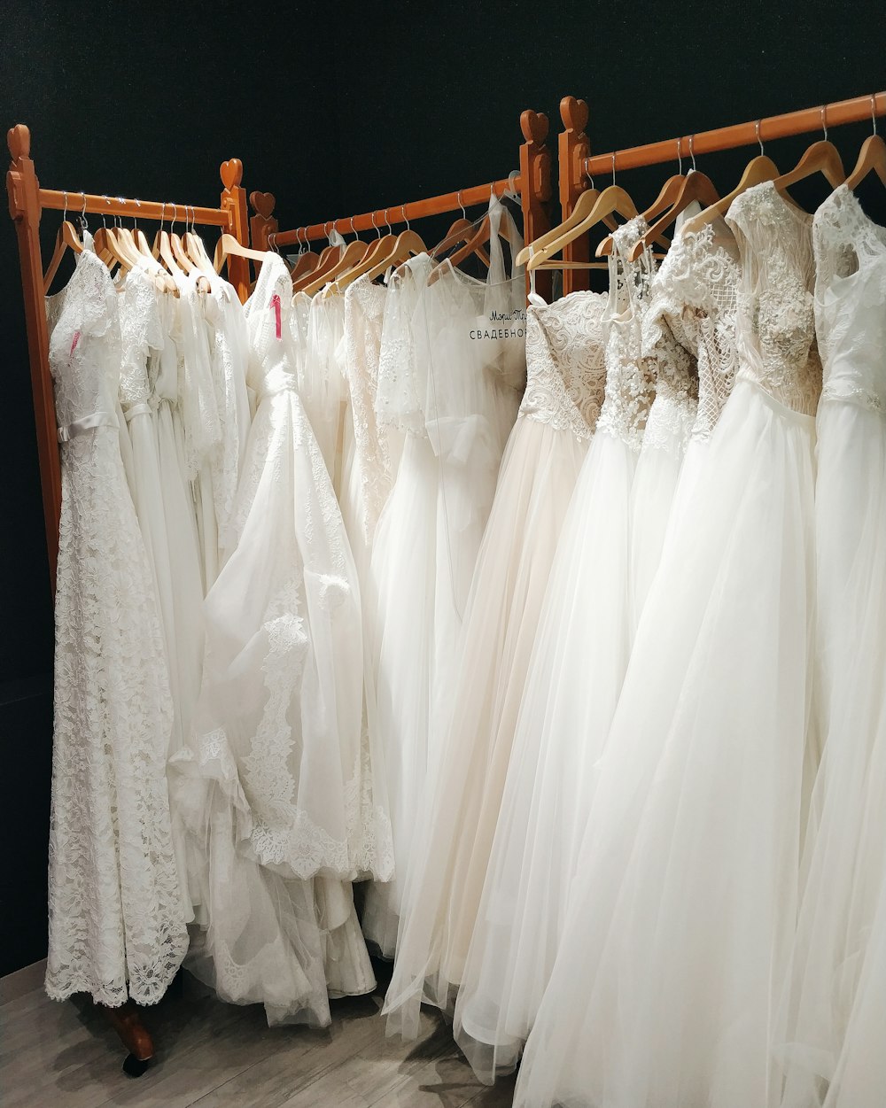 white gowns on wooden rack