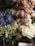 A beautifully arranged bouquet of white and blush roses with greenery.