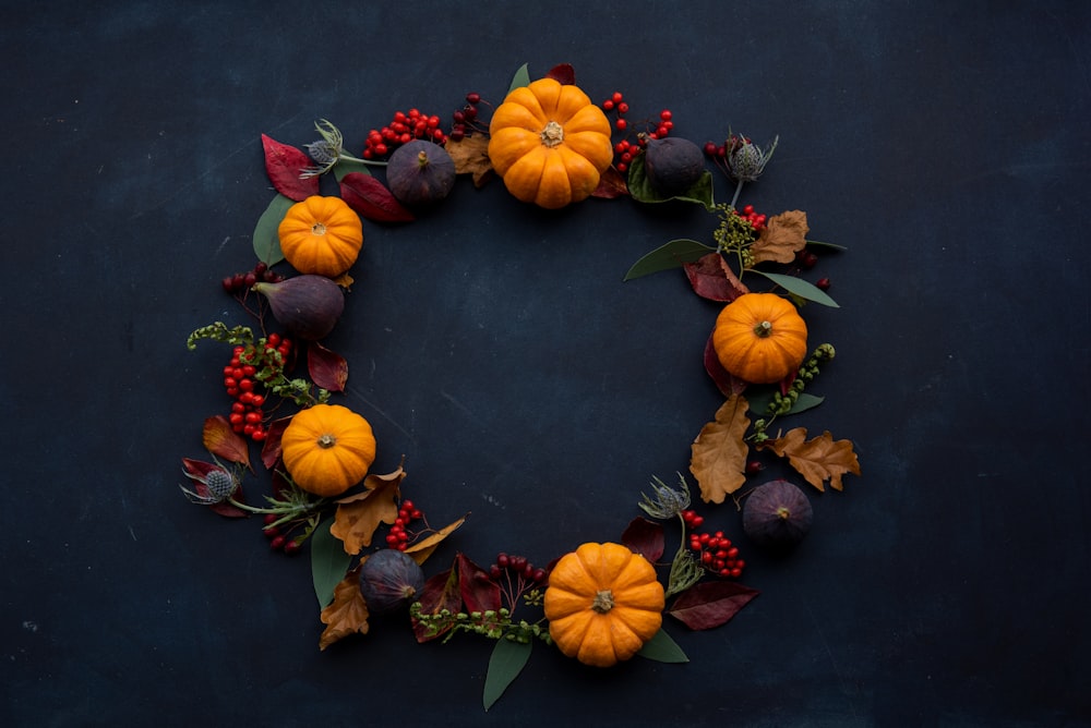 round Halloween-themed wreath on blue surface