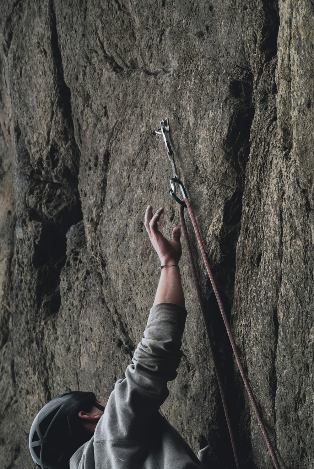 man climbing on rock