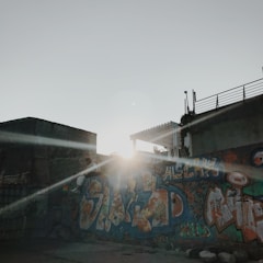 Sunset over a mural painted on a city wall.
