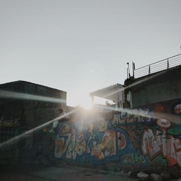 Sunset over a mural painted on a city wall.