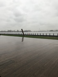 A contractor measuring and planning a waterfront deck renovation.