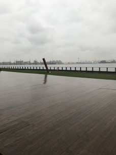 A contractor measuring and planning a waterfront deck renovation.