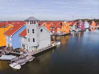 gray and brown houses beside body of water