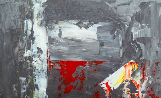 An abstract painting featuring a mix of bold brushstrokes in gray, white, red, and yellow. The composition is uneven, with streaks and patches of color blending dynamically, creating a sense of movement and chaos.