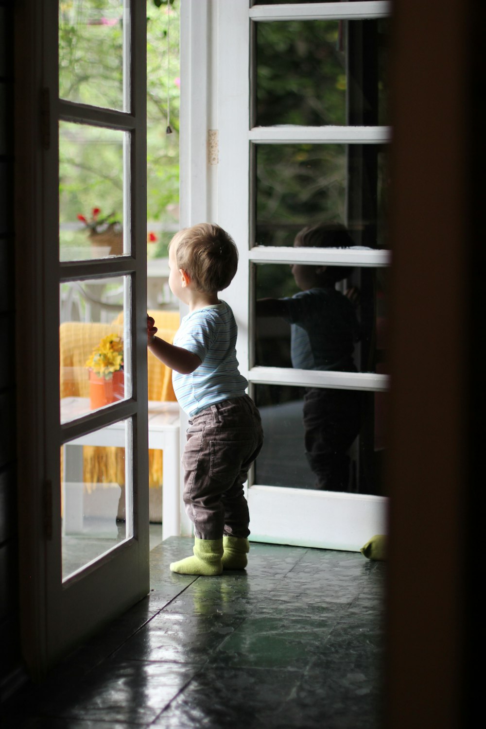 toddler standing beside door