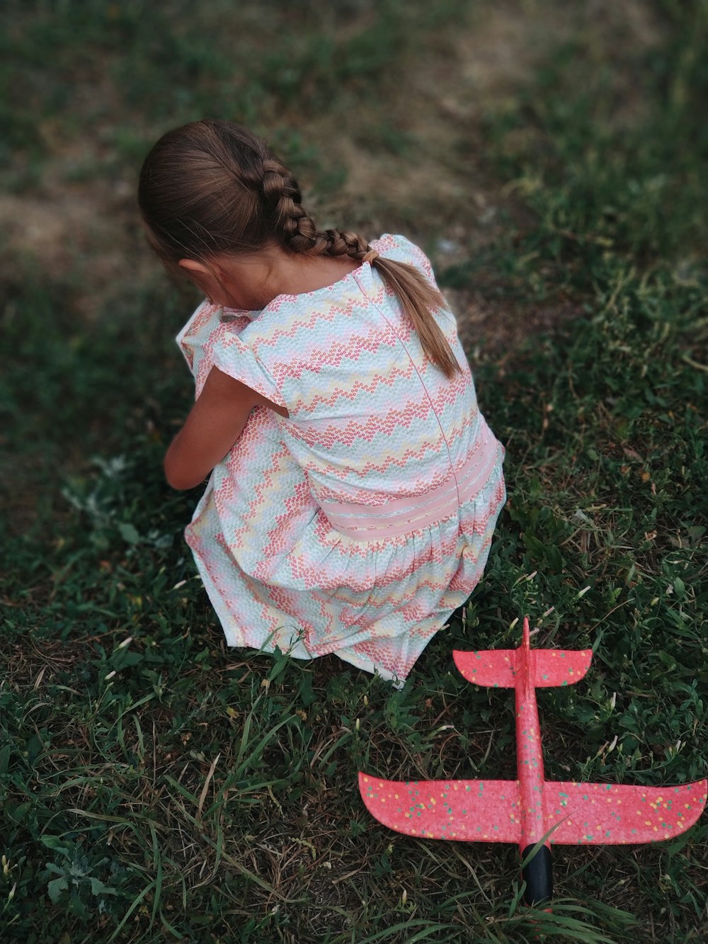 girl sitting on green grass