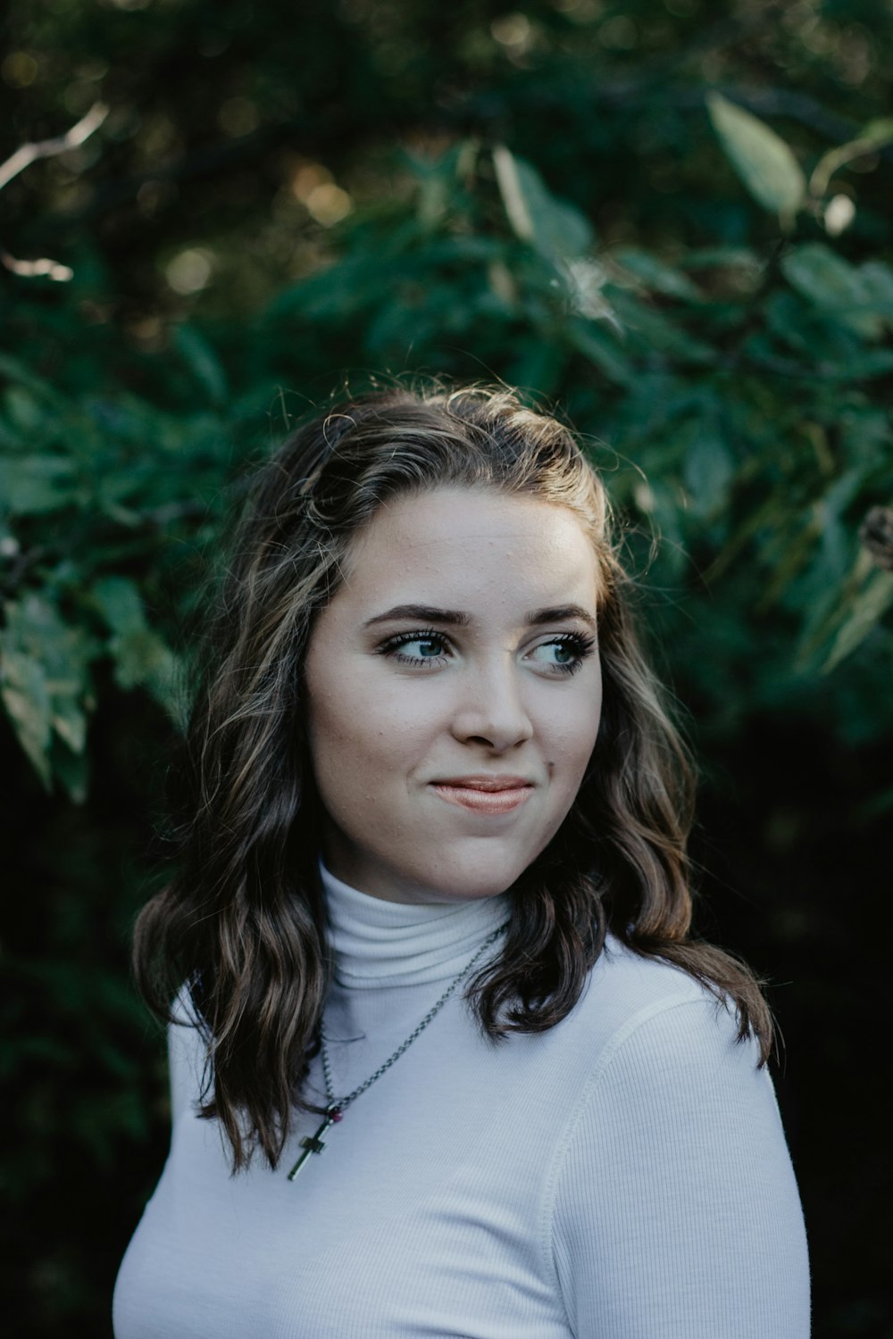 smiling woman wearing white turtleneck top