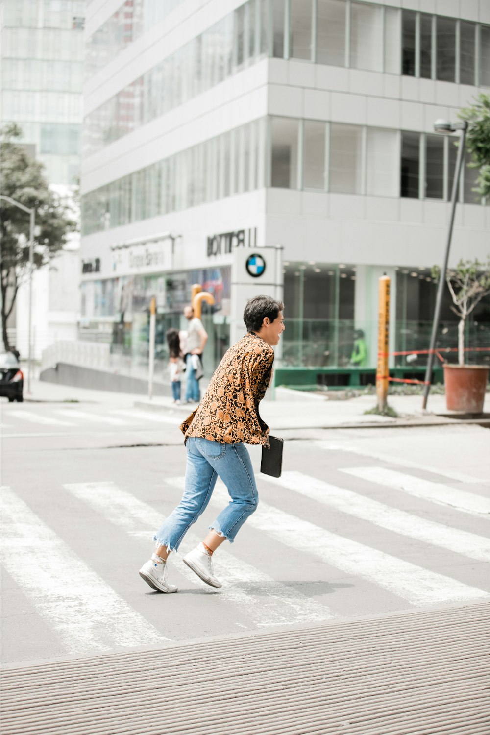 person wearing brown top running near concrete building during daytime