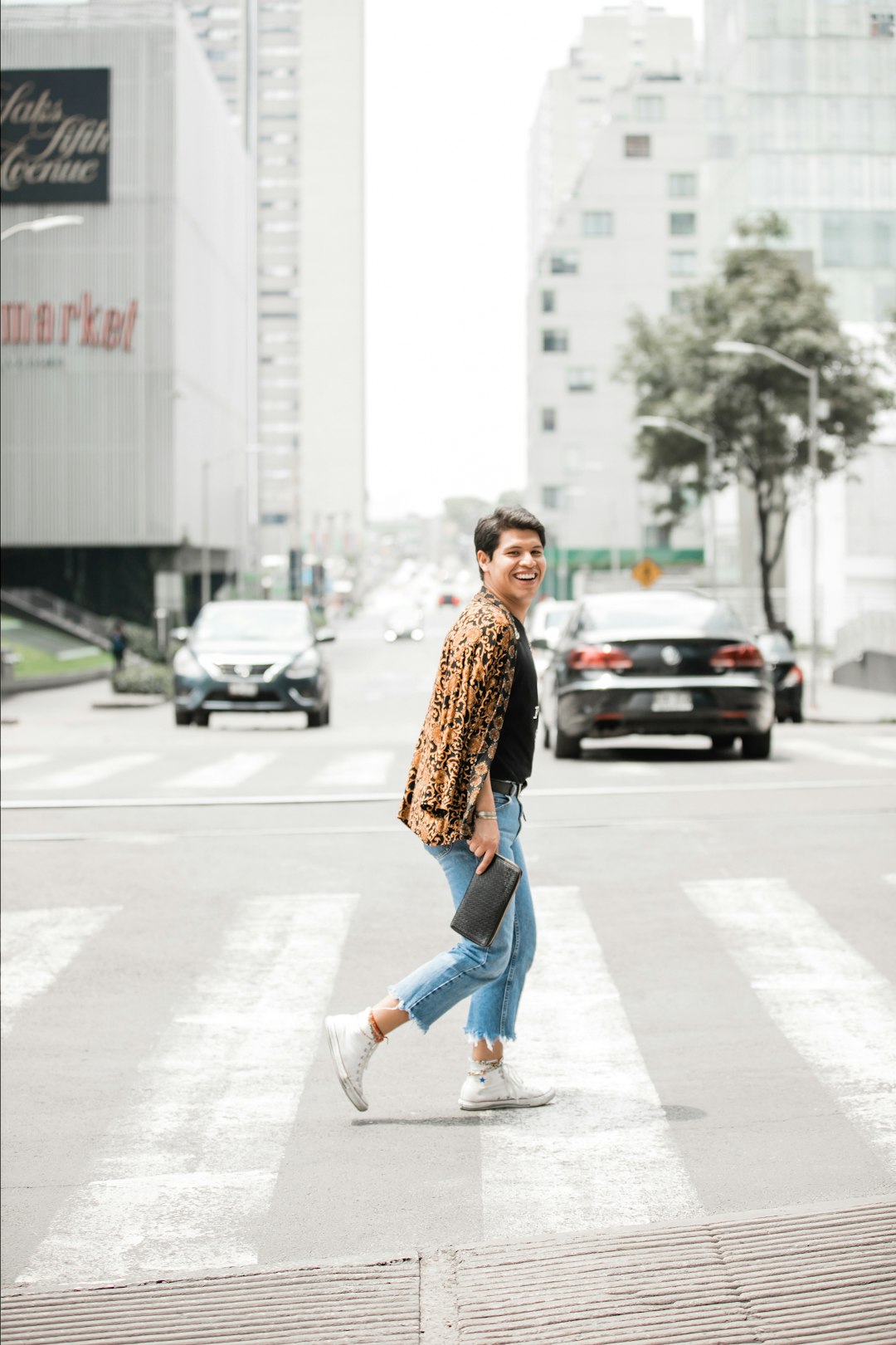 person wearing brown jacket walking on street