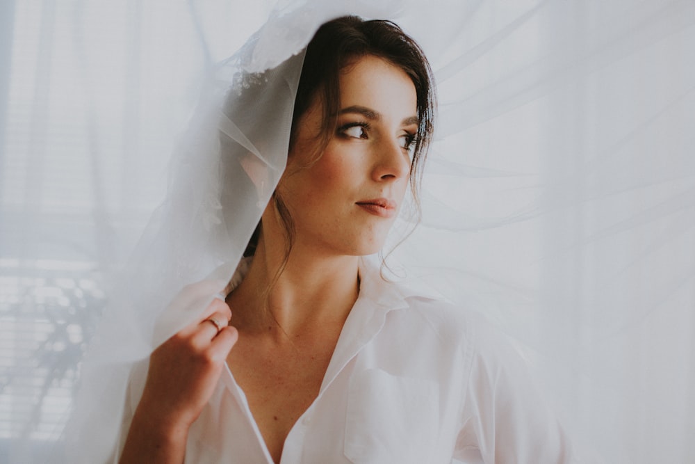 woman wearing white collared top with veil