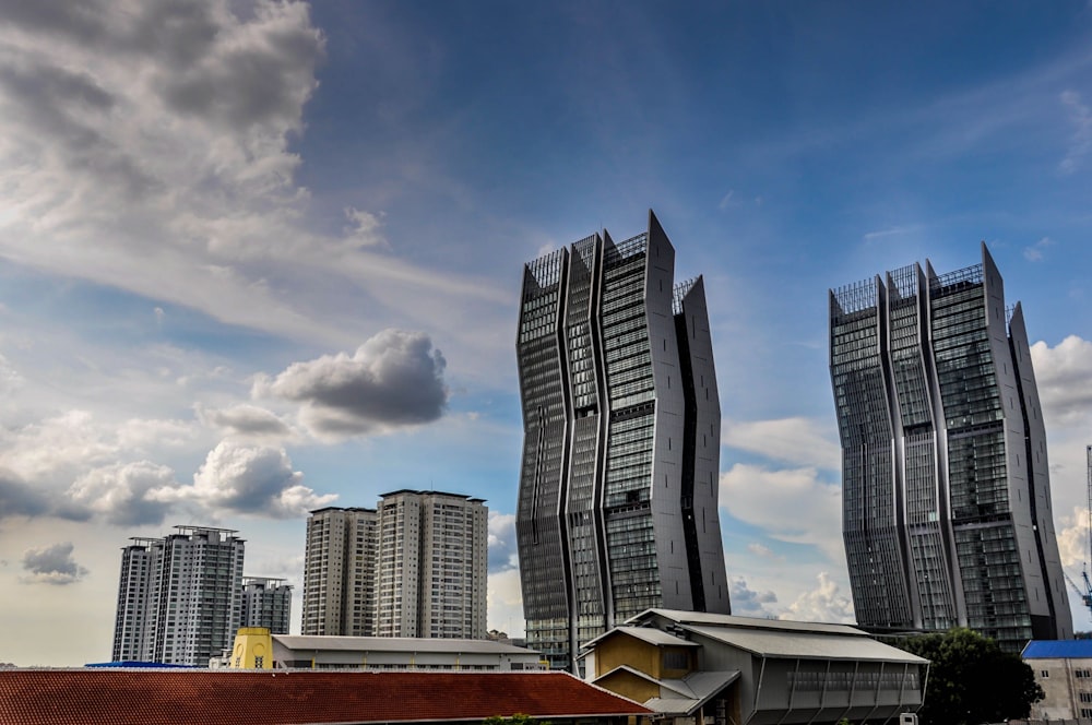 high-rise buildings under white and blue sky