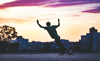 A vibrant sunset silhouette of a skateboarder jumping mid-air.