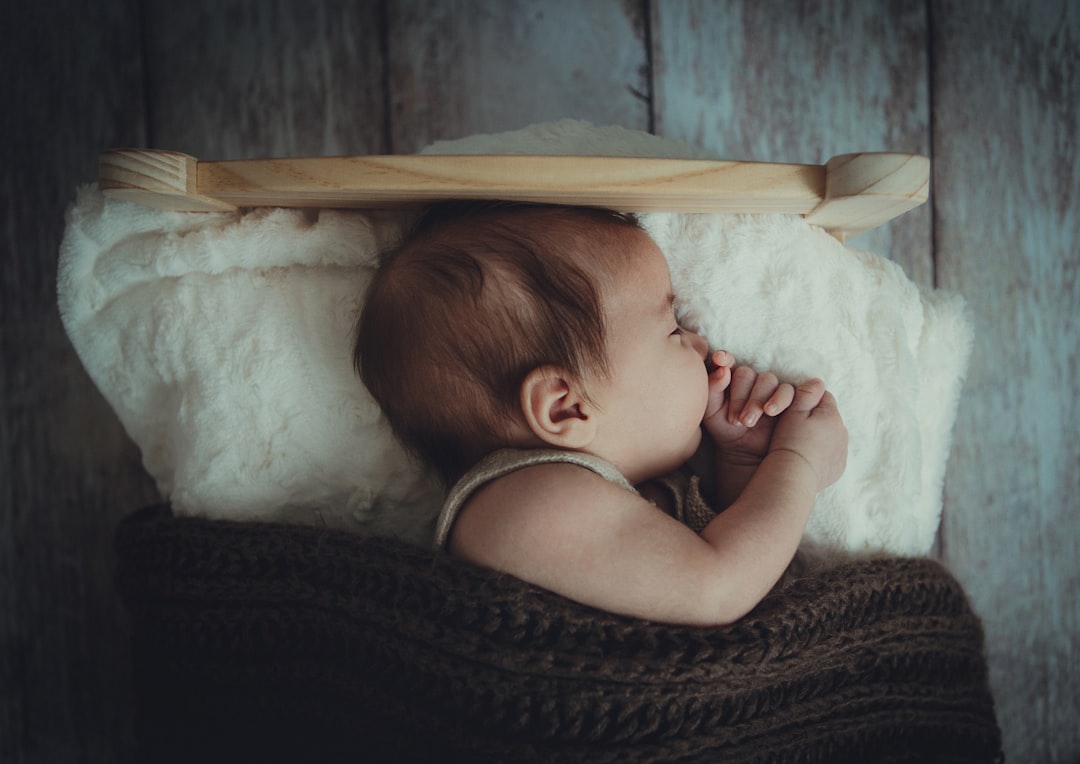 baby's sleeping on white comforter